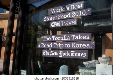 Tigard, OR, USA - Sep 8, 2021: The New York Times And CNN Travel's Endorsements Are Seen On The Storefront Window Of Koi Fusion, An Asian Eatery And A Small Business In Tigard, Oregon.