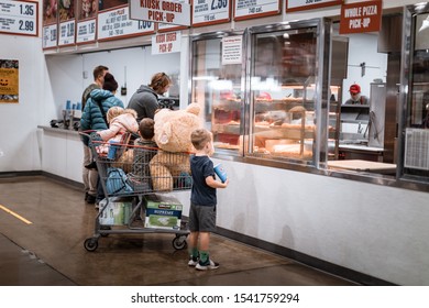 Tigard, Oregon - Oct 25, 2019 : A Family Are Purchasing Food With Piled Products Cart At The Food Court Of Costco Store