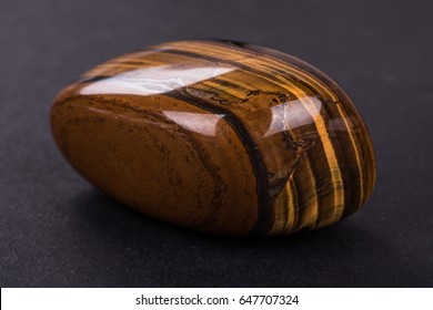 Tiger Eye Geode On Black Background. Beautiful Natural Crystal Gemstone.