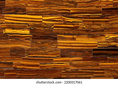 Tiger Eye Golden. Semiprecious texture as background. Mineral quartz beautiful golden-brown color with silky sheen. Material texture for unique interior, exterior design. Semi precious pattern - Shutterstock ID 2200317061