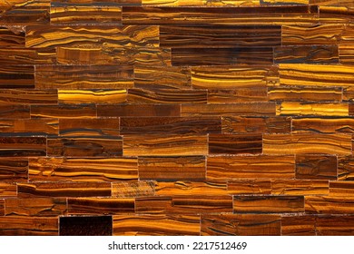Tiger Eye Golden. Semiprecious texture as background. Mineral quartz beautiful golden-brown color with silky sheen. Material texture for unique interior, exterior design. Semi precious pattern. - Shutterstock ID 2217512469
