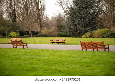 Tight frame with a few wooden benches near the Jubilee gates in Regent's Park.