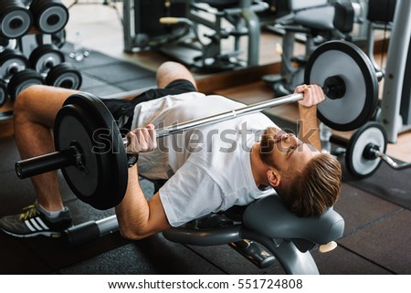 Similar – Image, Stock Photo man taking a weight plate in a gym