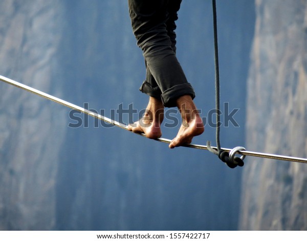  Tight rope highline walker over a high cliff    \
                          