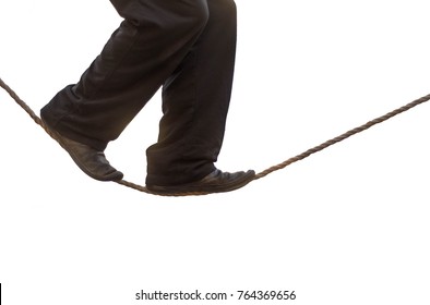 Tight Rope Walker's Legs Isolated. Feet Of Acrobat Balancing On Rope Against White Background