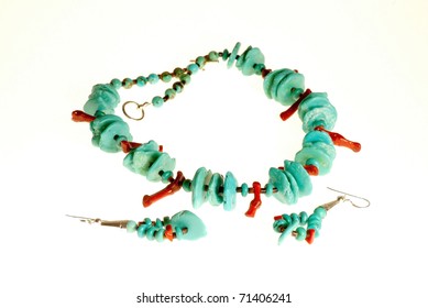 Tight Shot Of Handcrafted Native American Turquoise And Coral Jewelry Isolated On White Background.