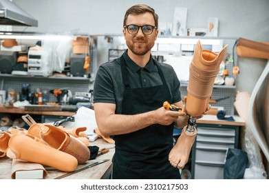 Tightening the screws. Technician working with prosthesis in modern laboratory. - Powered by Shutterstock