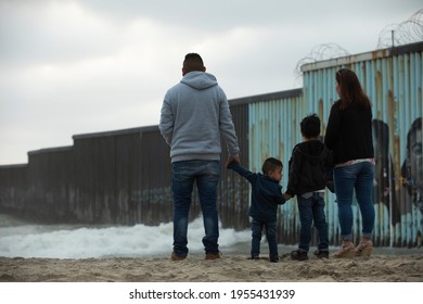 Tijuana, Baja California, Mexico - April 11, 2021: A Family Stands In Front Of The USA Mexico Border Wall.