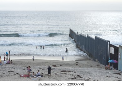 TIJUANA, MEXICO - JULY 26, 2014: Beach goers enjoy a day at the beach along the border fence in Tijuana, Mexico on a summer day