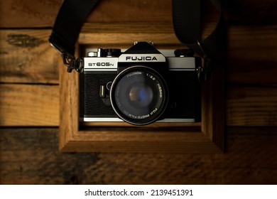 TIJUANA,MEXICO-MARCH 05,2022: Top Angle Of A Vintage Camera On A Rustic Wooden Background.