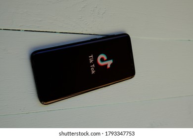 Tik Tok Abbreviation On The Phone On A Wooden White Board.  Kazan Russia August 2020