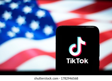 Tik Tok Logo Display On A Smartphone With The USA Flag As A Background. JUL 24, 2020: Bangalore, India.