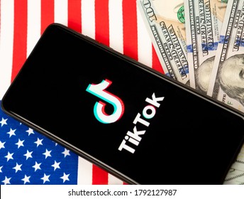 Tik Tok Logo On A Smartphone And US Dollars. Concept For Tik Tok Ban By Donald Trump. Russia, Kazan - August 08, 2020.