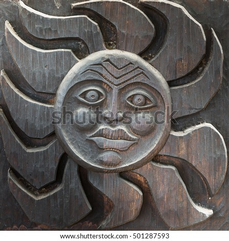Tiki carved statue on wood. Ancient sculpture of Hawaii