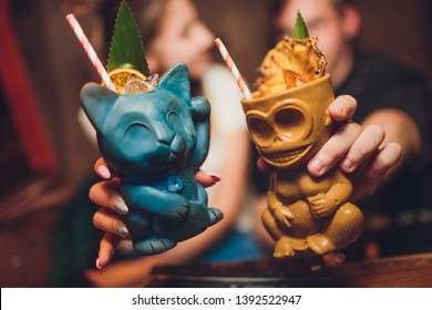 Tiki Drink Cocktails. Tropical Tiki Cocktails Man And Woman Are Holding.