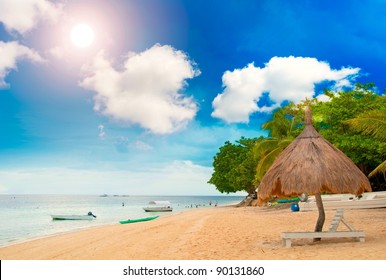 Tiki Hut On The Beach With Sun Beds