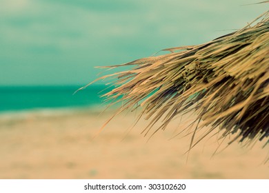 Tiki hut on the beach - textured old paper background