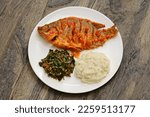 Tilapia stew, ugali(white maize flour mash) and Sukuma Wiki(kale stew), Kenyan food