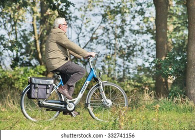 TILBURG-HOLLAND-OCT. 4, 2015. Senior on a Giant e-bike. Giant is a Taiwanese company, recognized as the world's largest bicycle manufacturer with production facilities in Taiwan, Holland and China.