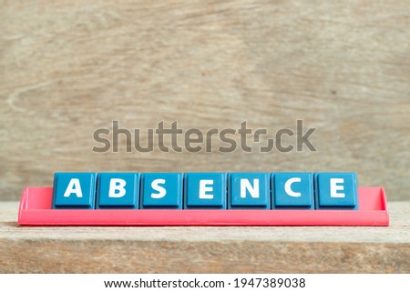 Tile alphabet letter with word absence in red color rack on wood background
