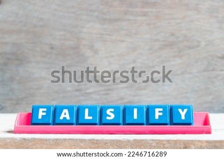 Tile alphabet letter with word falsify in red color rack on wood background