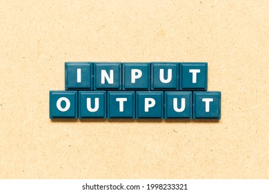 Tile alphabet letter in word input output on wood background