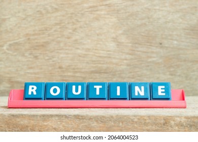 Tile alphabet letter with word routine in red color rack on wood background - Shutterstock ID 2064004523