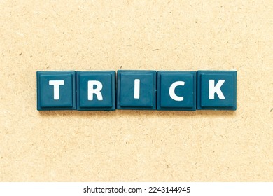 Tile alphabet letter in word trick on wood background - Shutterstock ID 2243144945