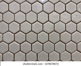 Tile Tile In The Form Of A Gentle Hexagon Light Grey Glossy. For The Bathroom Or Kitchen Work Area.