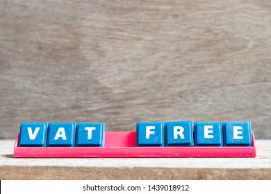 Tile letter on red rack in word vat (value added tax) free on wood background