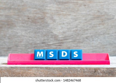 Tile Letter On Red Rack In Word MSDS (Abbreviation Of Material Safety Data Sheet) On Wood Background