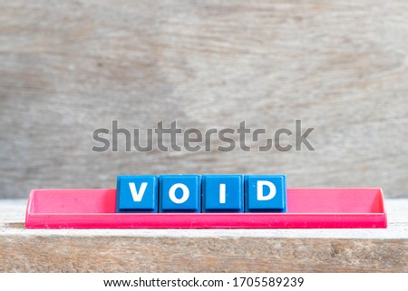 Tile letter on red rack in word void on wood background