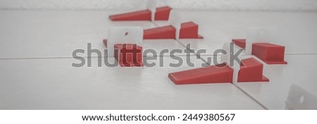 Tile Leveling System Components The image showcases essential tools for precise tile installation, featuring a tile leveling system designed to ensure uniform flatness and prevent lippage. 