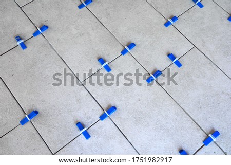 Tile leveling system with plastic clips and wedges, shot while the tile mortar sets
