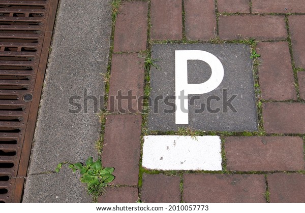Tile with a P on it to show the place is\
suitable for parking.
