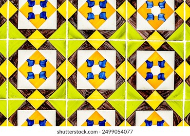 A tile pattern with yellow, green, and white tiles. The tiles are arranged in a way that creates a sense of movement and energy. The blue tiles add a pop of color and contrast to the pattern