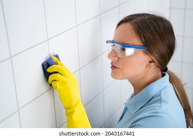 Tile Wall Grout Cleaning With Sponge And Goggles