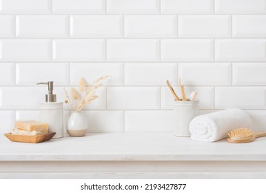 Tile wall and shelf in bathroom with various hygiene accessories