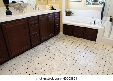 Tiled Bathroom Floor With A Modern Tub.