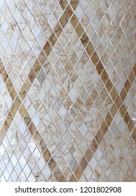 Tiled diamond repeating pattern in browns and creams as abstract background or texture