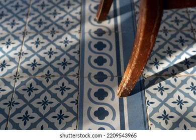 Tiled Old Floor And Wooden Chair Leg