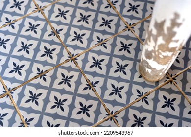 Tiled Old Floor And Wooden Chair Leg