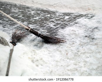 A Tiled Slippery Pavement In Particular Focus And A Broom,  Outdoor Sho