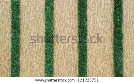 Tiled wall decorated with green grass
