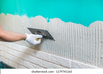 Tiler Applying Tile Adhesive On The Wall