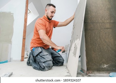 Tiler installing large format tile on wall. home indoors renovation
