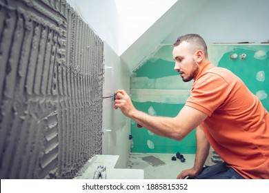 tiler installing large format tiles during home renovation 