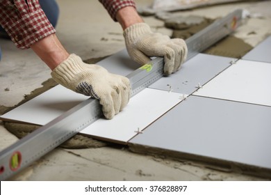 Tiler Installs Ceramic Tiles On A Floor