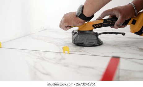 Tiler using tile leveling system for laying marble tiles ensuring perfect evenness and flawless finish