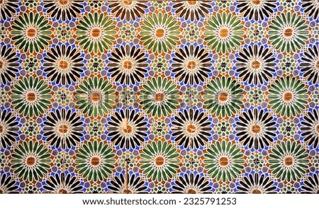 Tiles with a geometric design based on a twenty-pointed star. Decorative tile socle inside a house. Arabic style background. Talavera tiles. Spain